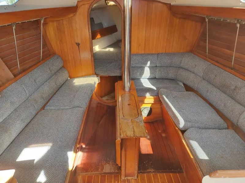 Slide: The Image of Interior of 1984 Elite 32 sailboat with wooden finish and cushioned seating. - 7