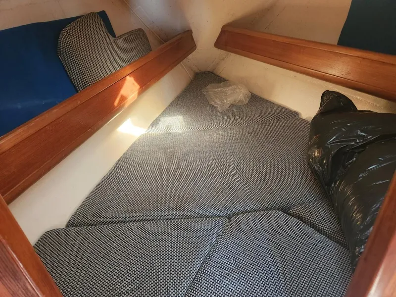 Slide: The Image of 1984 Elite 32 boat interior cabin with cushioned sleeping area. - 8