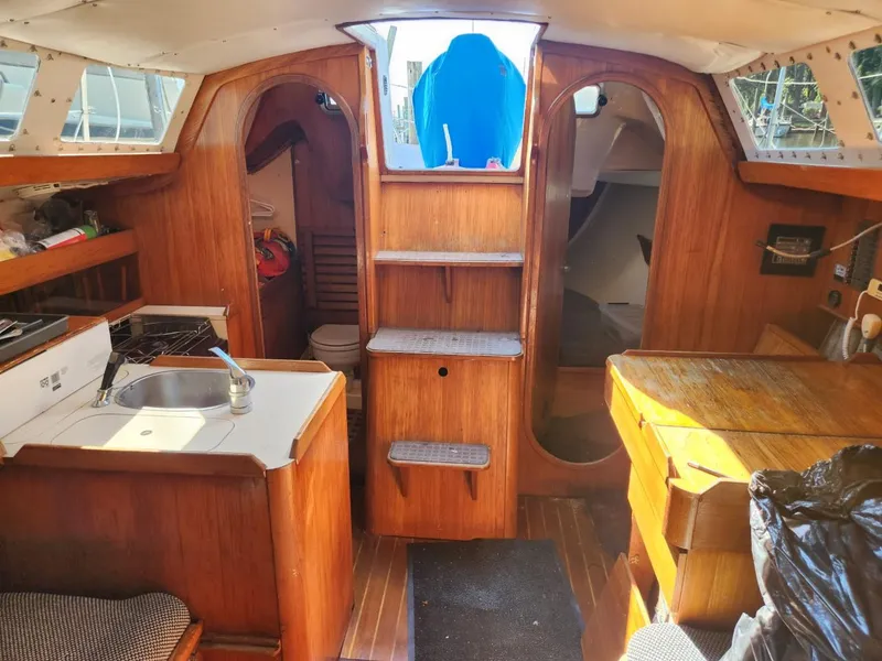Slide: The Image of Interior of 1984 Elite 32 sailboat with wooden cabinetry and compact kitchen. - 9