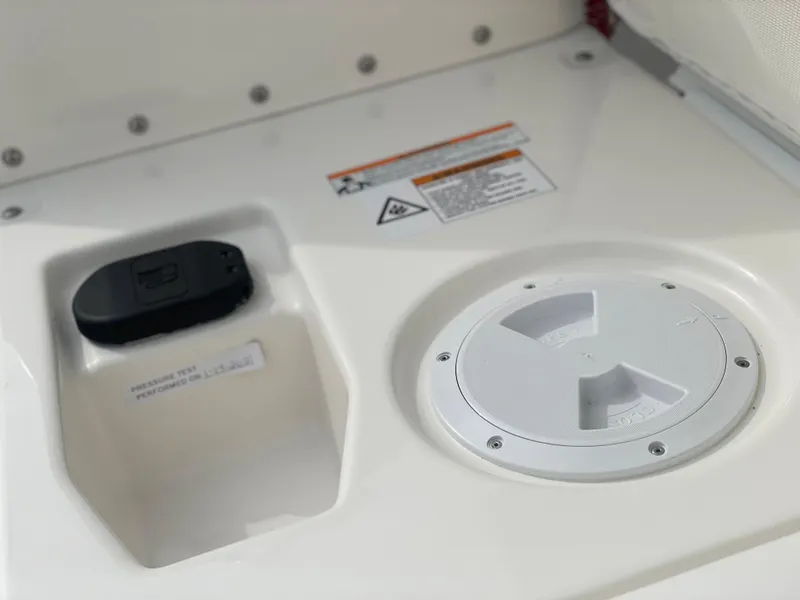 Slide: The Image of 2023 Zodiac Yachtline 490 Deluxe NEO 90hp control panel and storage compartment. - 26