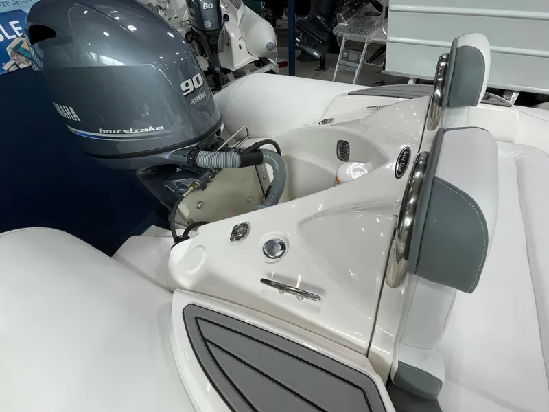 Slide: The Image of 2023 Zodiac Yachtline 490 Deluxe NEO 90hp boat engine and seating area. - 34