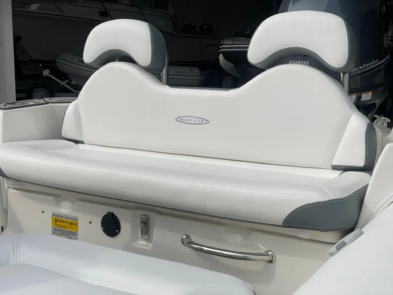 Slide: The Image of 2023 Zodiac Yachtline 490 Deluxe NEO 90hp boat seating area with white and gray upholstery. - 9