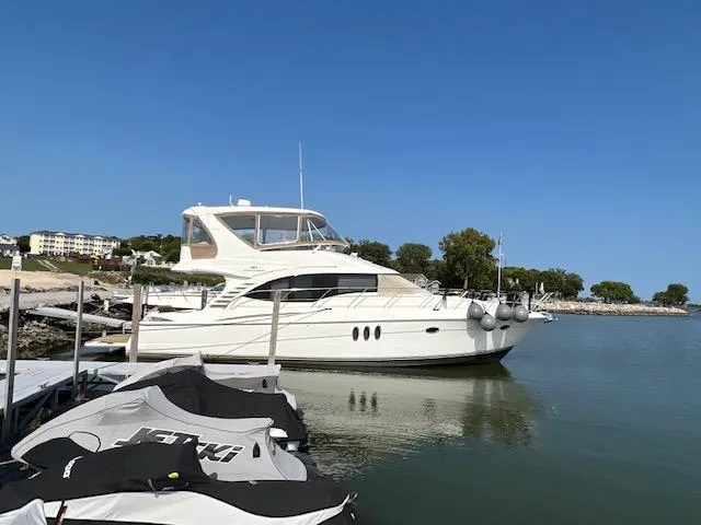 Slide: The Image of Luxury 2009 Ovation 52 yacht docked at marina with jet skis in foreground. - 0