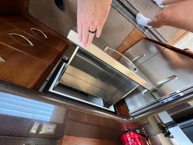 Slide: The Image of Man opening refrigerator in 2009 Ovation 52 yacht kitchen. - 10