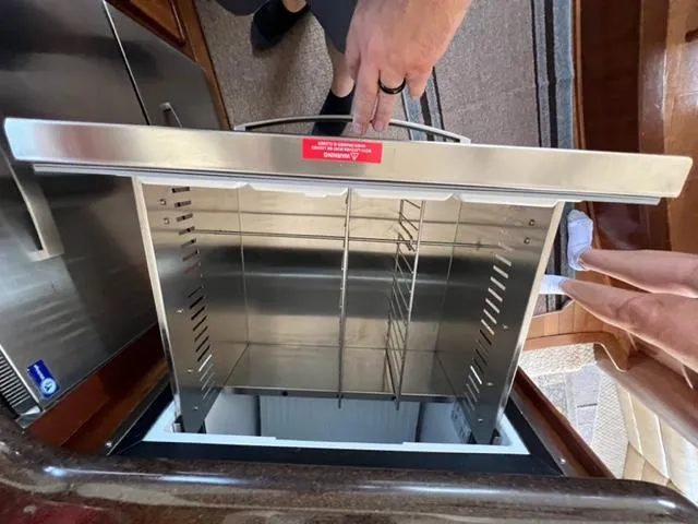Slide: The Image of Open stainless steel drawer in a 2009 Ovation 52 yacht kitchen. - 11