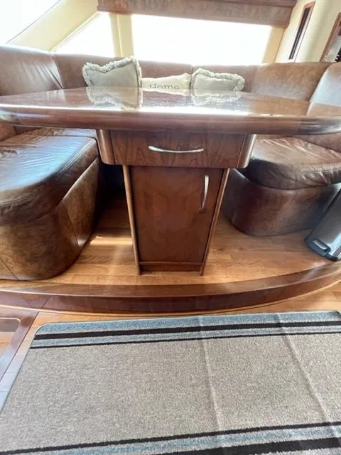 Slide: The Image of Luxurious wooden dining area in a 2009 Ovation 52 yacht. - 17