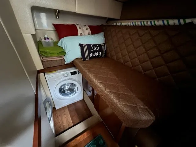 Slide: The Image of Compact cabin interior of a 2009 Ovation 52 yacht with washer and cozy bed. - 19