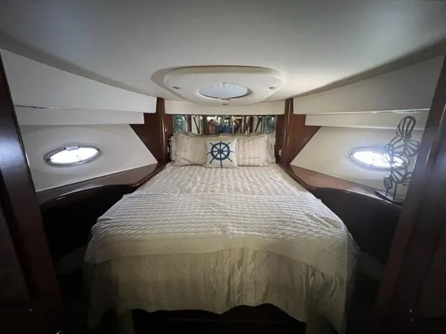 Slide: The Image of Luxurious bedroom in a 2009 Ovation 52 yacht with nautical decor. - 21