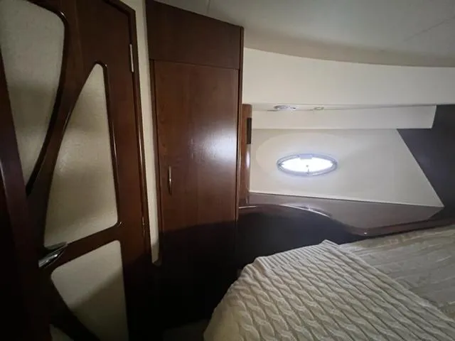 Slide: The Image of Interior cabin of a 2009 Ovation 52 yacht with wooden cabinetry and a porthole window. - 22