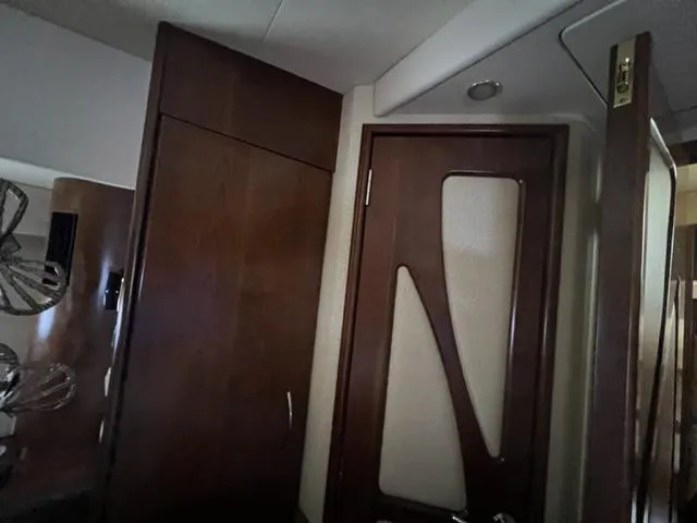 Slide: The Image of Interior of a 2009 Ovation 52 yacht with wooden cabinetry and modern door design. - 23