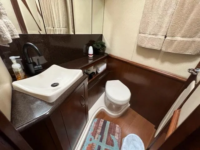 Slide: The Image of 2009 Ovation 52 yacht bathroom with sink, toilet, and storage. - 25
