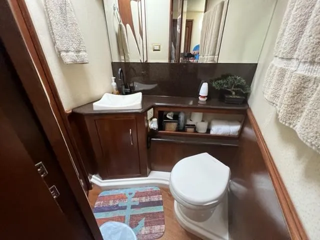 Slide: The Image of Compact bathroom in a 2009 Ovation 52 yacht with sink, toilet, and storage. - 28