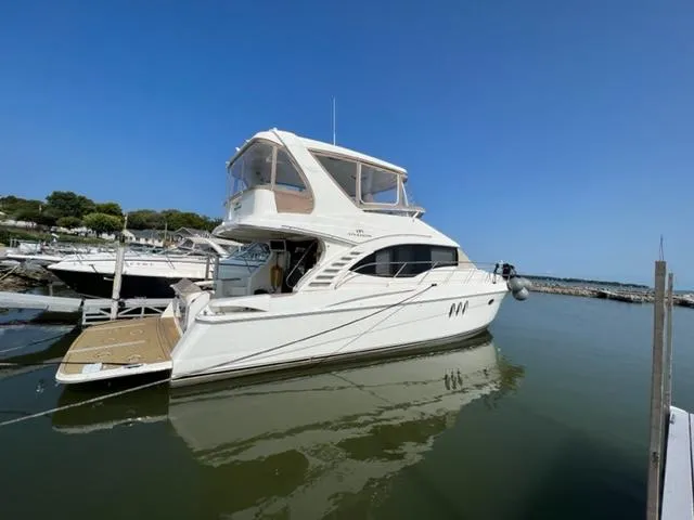 Slide: The Image of 2009 Ovation 52 yacht docked at a marina on a sunny day. - 3