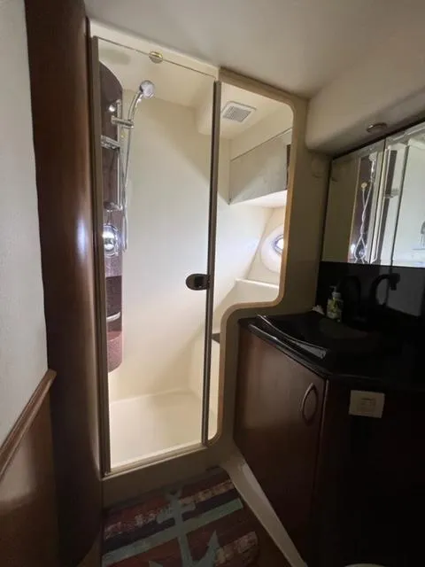 Slide: The Image of Compact bathroom in a 2009 Ovation 52 yacht with shower and sink. - 30