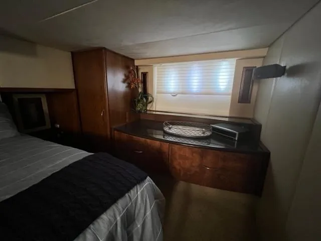 Slide: The Image of Luxurious bedroom interior of 2009 Ovation 52 yacht with wooden cabinetry and window. - 33