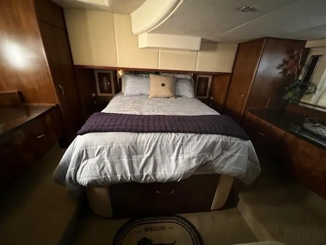 Slide: The Image of Luxurious bedroom in a 2009 Ovation 52 yacht with a cozy bed and elegant wood finishes. - 34