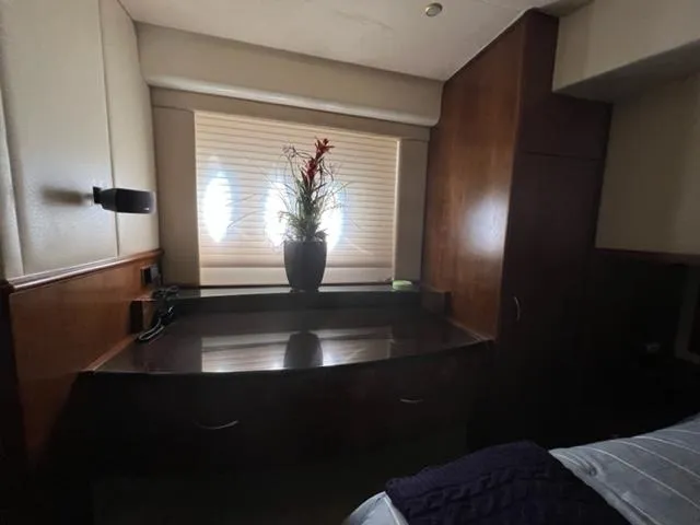 Slide: The Image of Luxurious interior of 2009 Ovation 52 yacht with wooden cabinetry and decorative plant. - 35