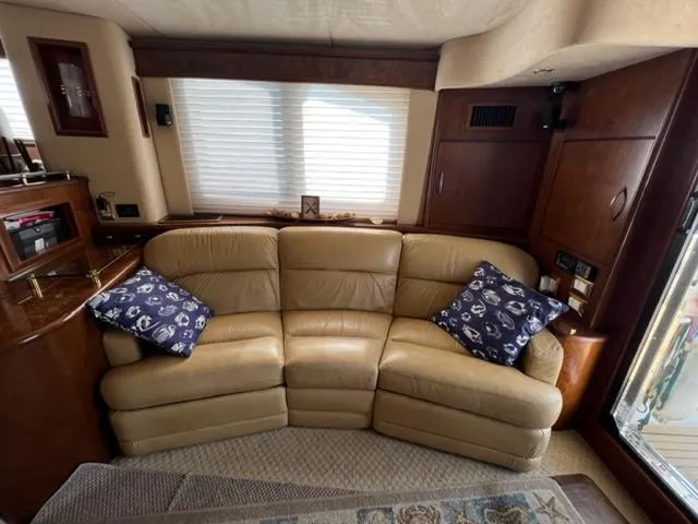 Slide: The Image of Luxurious leather sofa in 2009 Ovation 52 yacht interior with nautical-themed pillows. - 4