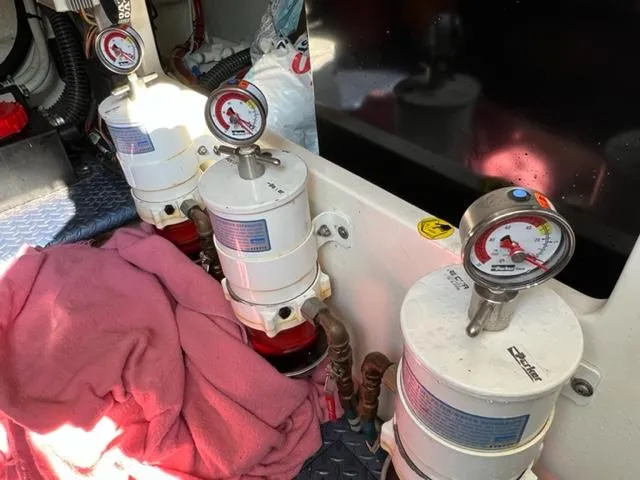 Slide: The Image of Fuel filters and pressure gauges in the engine room of a 2009 Ovation 52 boat. - 40