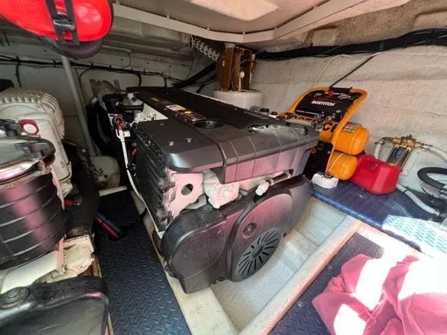 Slide: The Image of Engine room of a 2009 Ovation 52 yacht with visible machinery and equipment. - 41