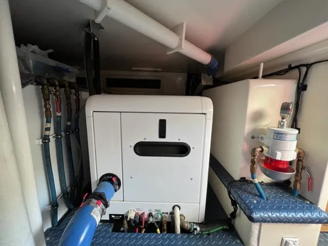 Slide: The Image of Engine room of a 2009 Ovation 52 yacht with plumbing and electrical systems. - 46