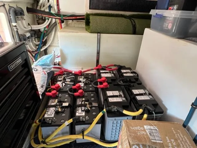 Slide: The Image of Battery compartment of a 2009 Ovation 52 yacht with multiple batteries and wiring. - 48