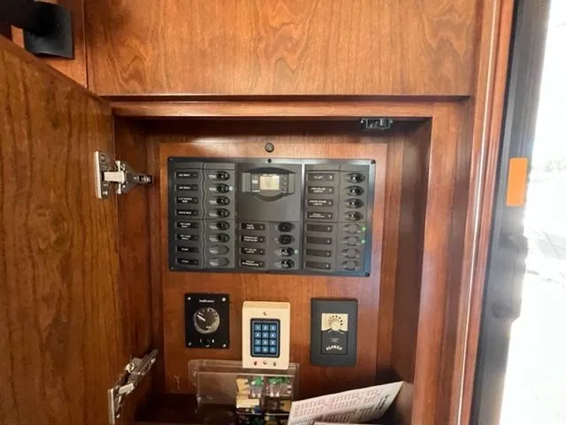 Slide: The Image of Control panel inside a 2009 Ovation 52 yacht with wooden cabinetry. - 5