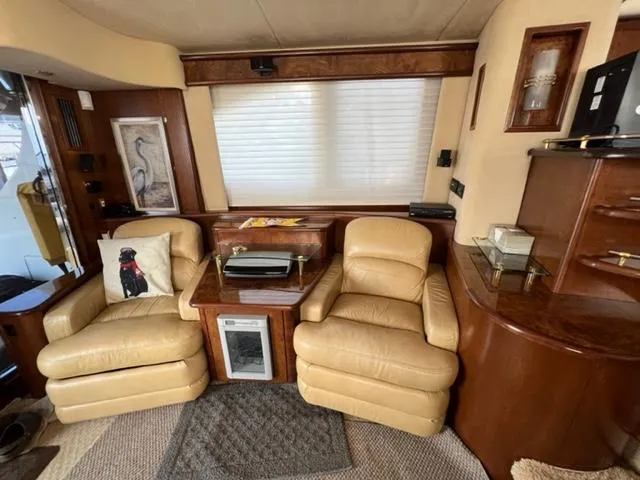 Slide: The Image of Luxurious 2009 Ovation 52 yacht interior with leather chairs and wooden cabinetry. - 8