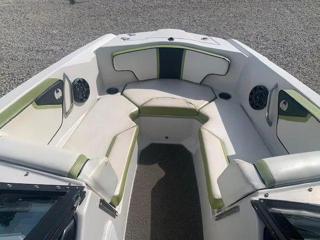 Slide: The Image of 2014 Scarab 215 boat interior with white and green seating. - 10