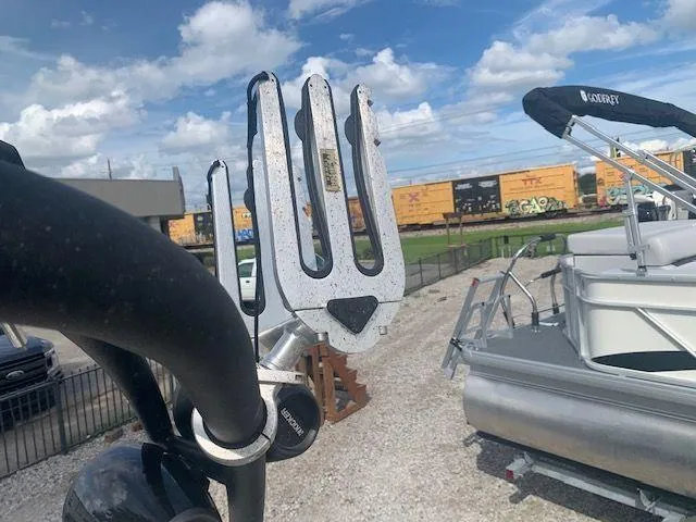 Slide: The Image of Wakeboard rack on a 2014 Scarab 215 boat, with a train in the background. - 15