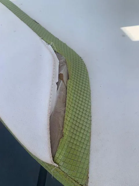 Slide: The Image of Torn upholstery on a 2014 Scarab 215 boat seat. - 17