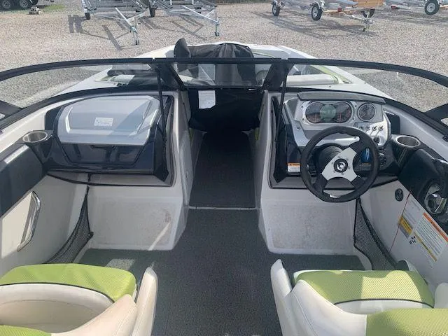 Slide: The Image of 2014 Scarab 215 boat interior with steering wheel and seating. - 9