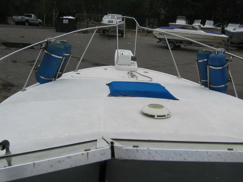 Slide: The Image of 1983 Bayliner 2850 Contessa boat deck with blue fenders in a marina. - 12