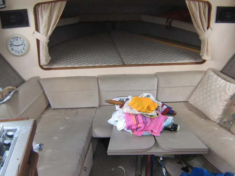 Slide: The Image of Interior of 1983 Bayliner 2850 Contessa with beige seating and a small table. - 17