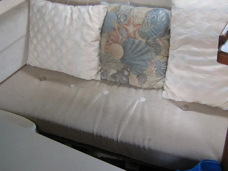 Slide: The Image of 1983 Bayliner 2850 Contessa interior seating with decorative pillows. - 19