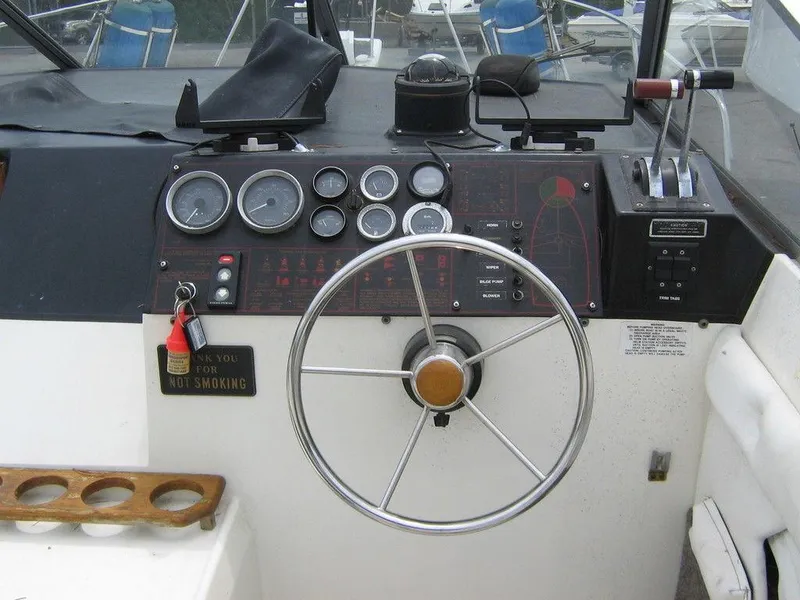 Slide: The Image of 1983 Bayliner 2850 Contessa boat helm with steering wheel and control panel. - 2