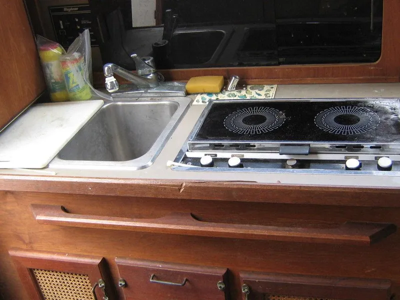 Slide: The Image of 1983 Bayliner 2850 Contessa kitchen with sink and stove. - 20