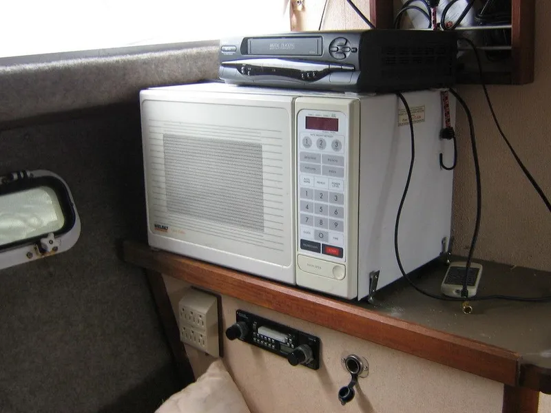 Slide: The Image of Microwave and electronic equipment inside a 1983 Bayliner 2850 Contessa boat. - 4