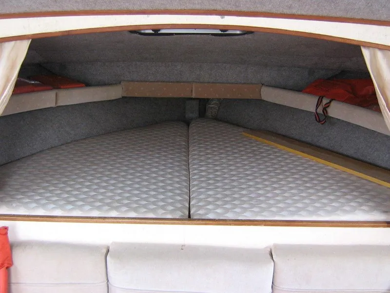 Slide: The Image of 1983 Bayliner 2850 Contessa cabin interior with bed and storage compartments. - 7
