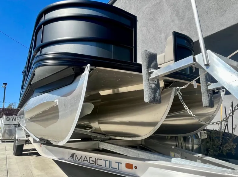 Slide: The Image of 2025 Barletta Lusso 23UC pontoon boat on Magic Tilt trailer, close-up view. - 23