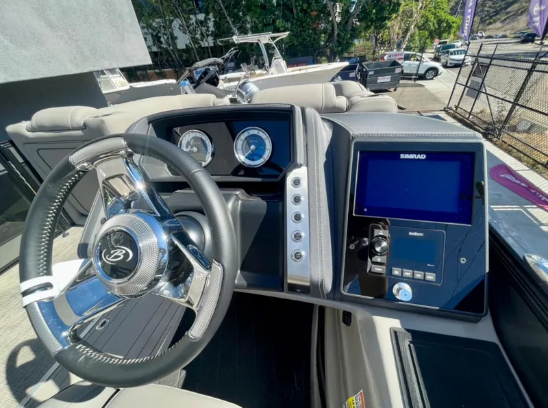 Slide: The Image of 2025 Barletta Lusso 23UC boat dashboard with steering wheel and navigation display. - 5
