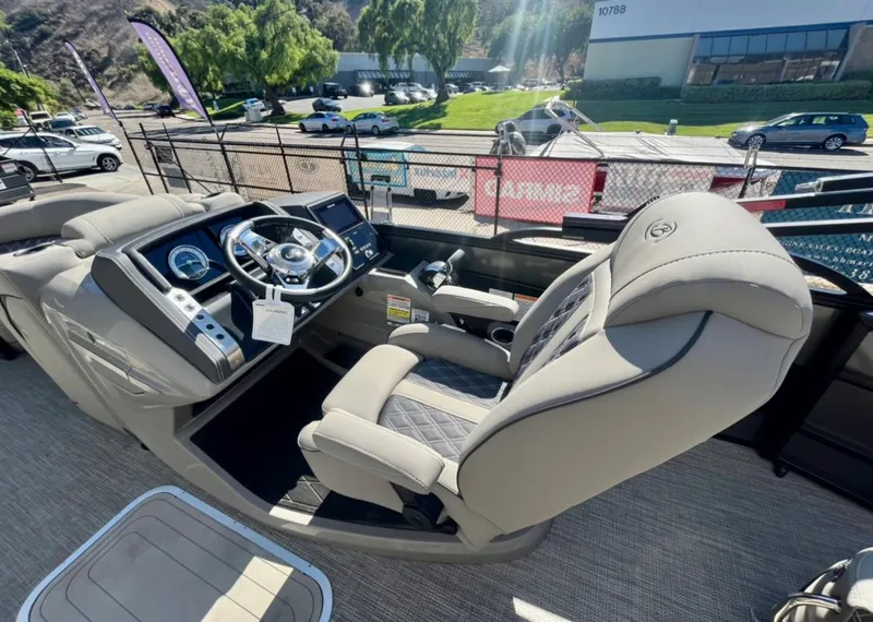 Slide: The Image of 2025 Barletta Lusso 23UC boat interior with luxurious captain's chair and modern dashboard. - 6