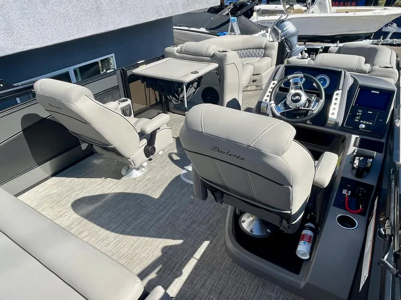 Slide: The Image of Luxurious 2025 Barletta Lusso 23UC boat interior with plush seating and modern helm. - 7