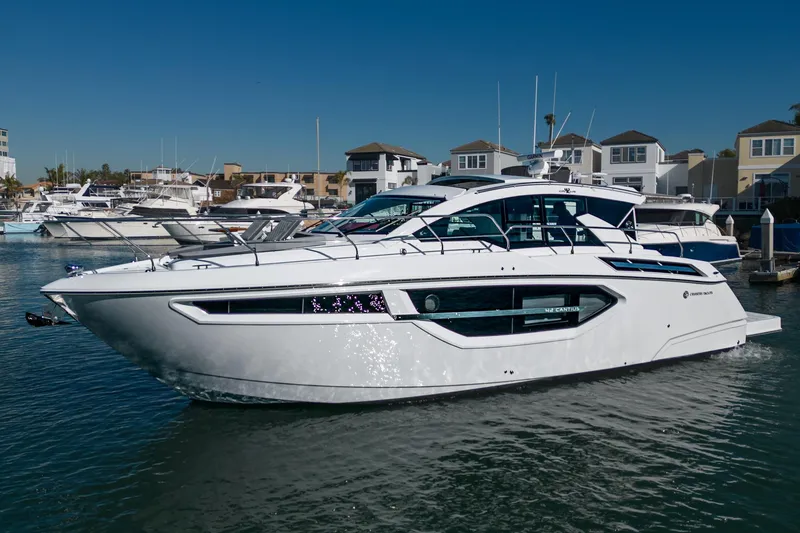 The Image of 2023 Cruisers Yachts 42 Cantius luxury boat docked in a marina. - 1