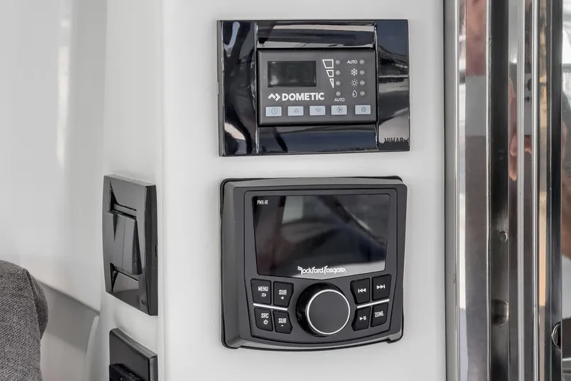 Slide: The Image of Control panels on the 2023 Cruisers Yachts 42 Cantius, featuring Dometic and Rockford Fosgate systems. - 23