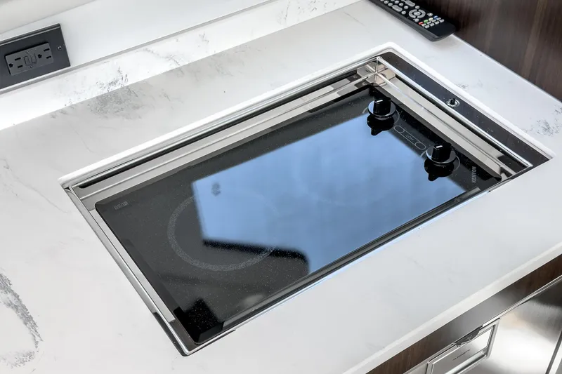 Slide: The Image of Modern stovetop in the 2023 Cruisers Yachts 42 Cantius galley. - 26