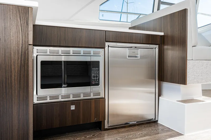 Slide: The Image of Modern kitchen area in 2023 Cruisers Yachts 42 Cantius with stainless steel appliances. - 27