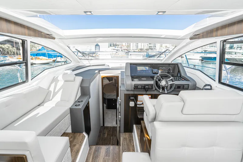 Slide: The Image of Interior of 2023 Cruisers Yachts 42 Cantius with modern helm and luxurious seating. - 29