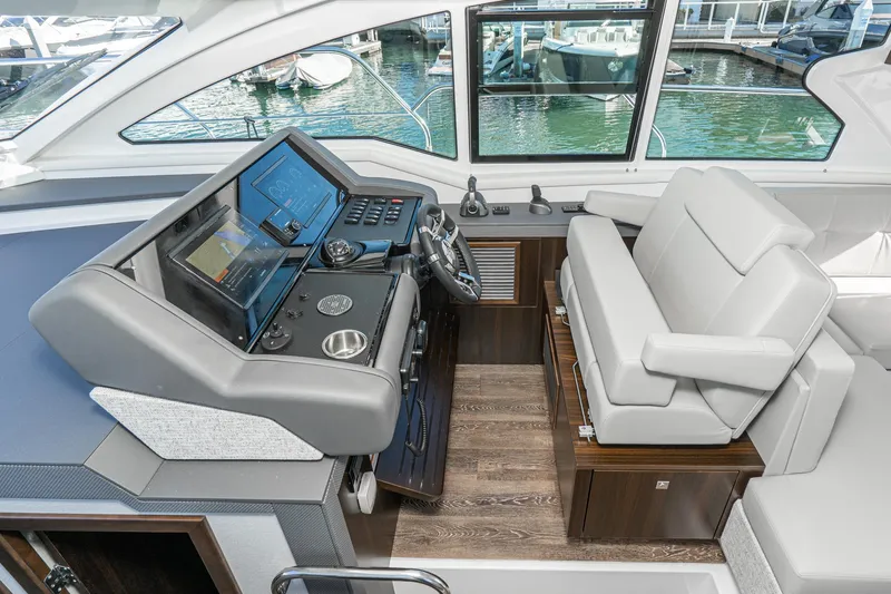 Slide: The Image of 2023 Cruisers Yachts 42 Cantius helm station with modern controls and comfortable seating. - 32