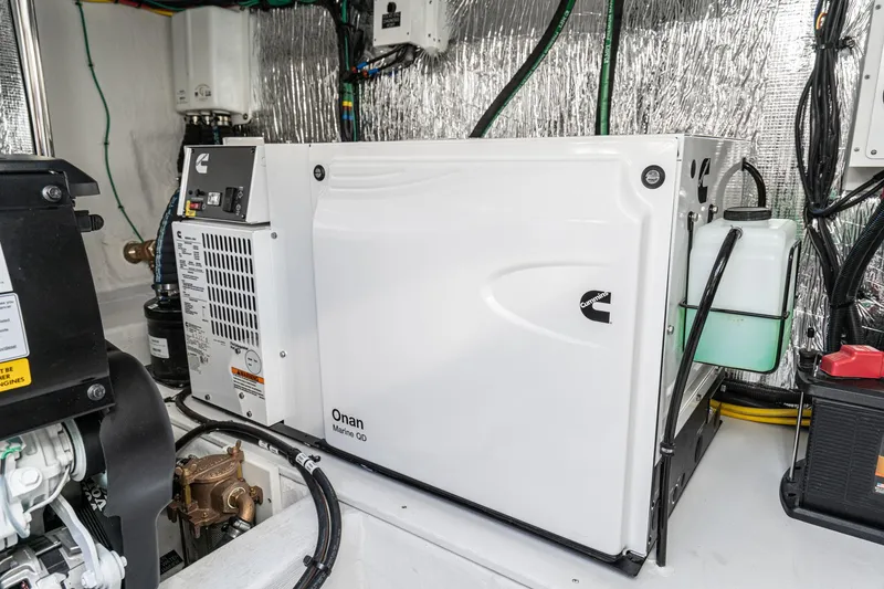Slide: The Image of Cummins Onan generator in the engine room of a 2023 Cruisers Yachts 42 Cantius. - 48